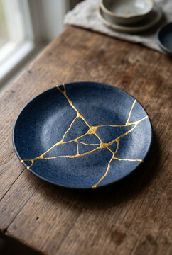 Kintsugi Plate: Japanese Art of Golden Repair on Dark Blue Ceramic