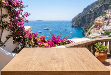 Fototapeta premium Empty wooden table overlooking a beautiful coastal summer town