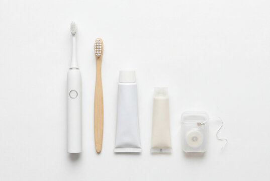 Minimalist arrangement of dental hygiene products including electric and bamboo toothbrushes