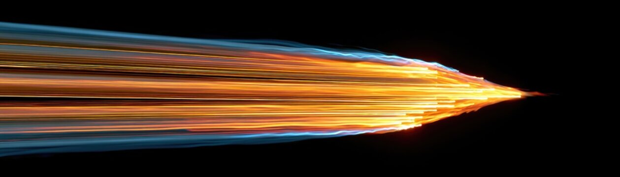 Streaks of orange fire and blue light move rapidly to the right against a black background