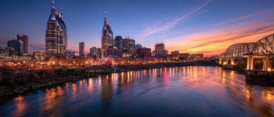 Fototapeta premium City skyline with a river and bridge at sunset