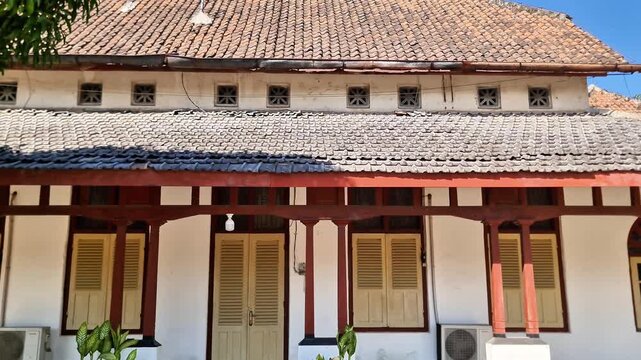 Architectural Detail of 1912 Dutch Colonial House with Paving and Mango Tree in Indonesia