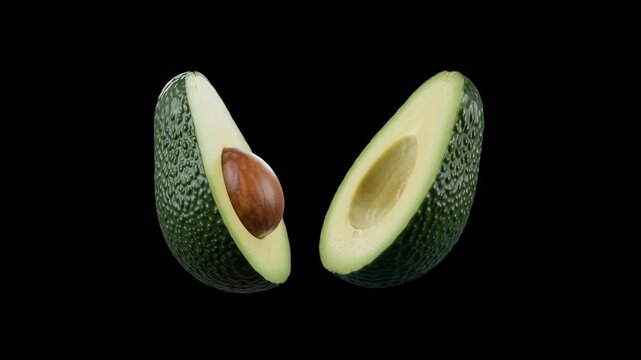 Two halves of a fresh green avocado, one with seed pit and one pitted, levitating gracefully against a solid dark backdrop. Suitable for superfood promo videos, guacamole recipe graphics, and healthy 