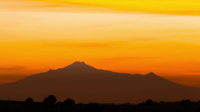 Golden sunrise over malinche volcano in mexico