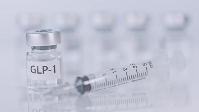 Clinical medical weight loss management therapy featuring sterile glass vial bottle and syringe dose injection treatment for diabetes obesity care