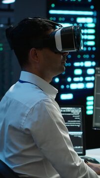 Vertical aspect: Admin using virtual reality for server maintenance in a high tech server farm using VR headset, connecting immersive visualization, technical diagnostics and infrastructure control.