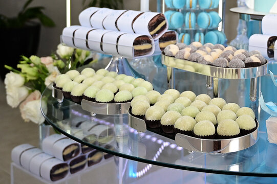 gourmet grape truffles on elegant celebration buffet, traditional brazilian wedding candy surpresa de uva, luxury dessert table catering presentation, sweet confectionery close up