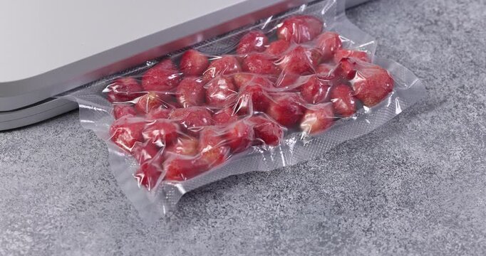 Vacuum-sealed fresh berries on a kitchen counter for meal prep,and preservation. Homemade kitchen concept. 
