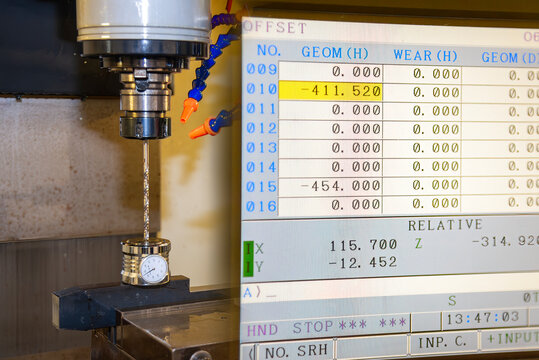 Abstract scene of a drill tool length measurement process on a CNC milling machine with a tool offset monitor screen.
