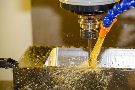 High-precision CNC milling machine performing a mold parts finish cut with oil coolant method and ball nose end mill.