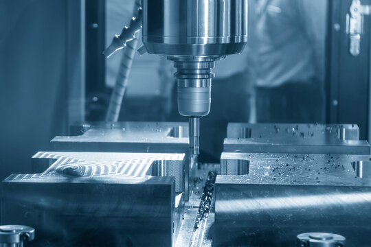 High-efficiency CNC milling machine performing a rough cutting process on a mold base part with an indexable tool.