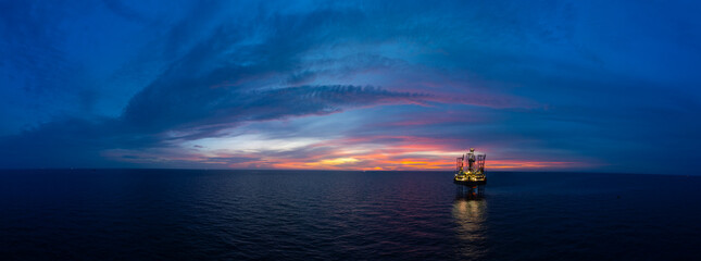 Fototapeta na wymiar Aerial panoramic view of offshore jack up rig and offshore platform for oil and gas exploration and production.