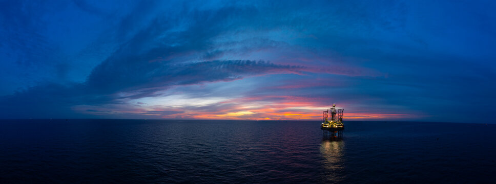 Aerial panoramic view of offshore jack up rig and offshore platform for oil and gas exploration and production.