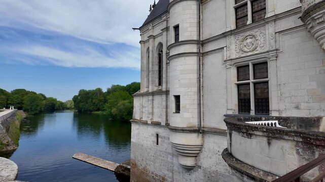 Elegant Renaissance architecture of Ch&acirc;teau de Chenonceau reflected in the calm waters of its surrounding moat during early summer