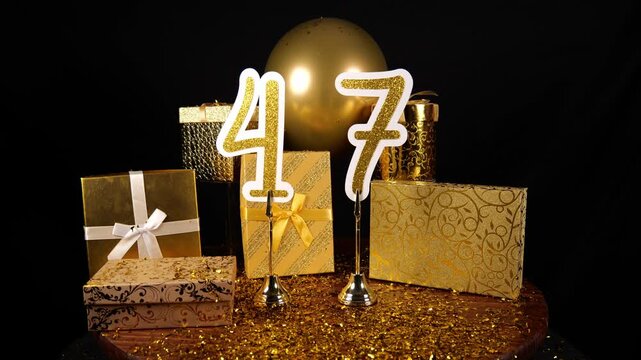 Gold Number 47 with Gold Glitter Confetti Sparkles with Gifts and Balloons for Party Forty Seven