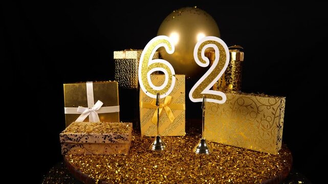 Gold Number 62 with Gold Glitter Confetti Sparkles with Gifts and Balloons for Party Sixty Two