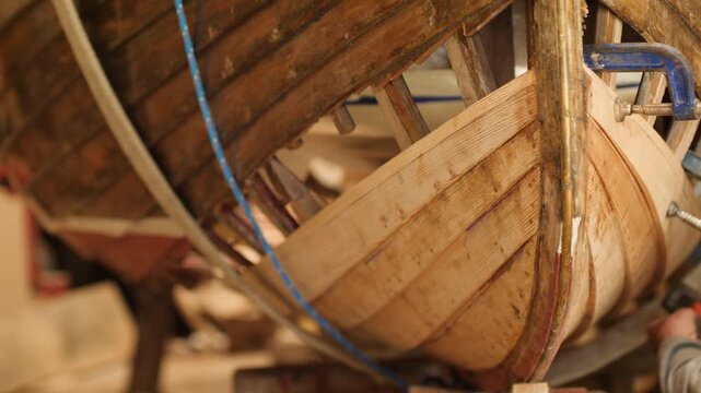Traditional lapstrake clinker wooden sailboat repaired hull planking