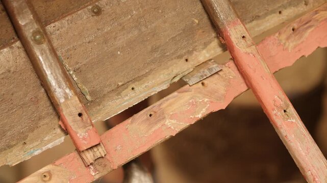Chiseling damaged hull plank on wooden boat