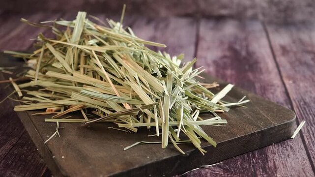Pile of Dried Lemongrass on a Wooden Cutting Board