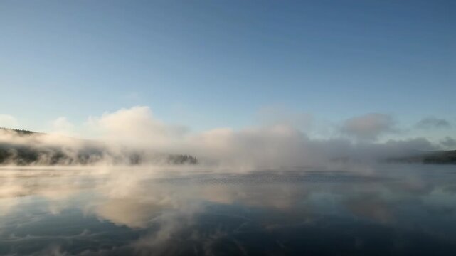 Morning Mist Over Tranquil Lake Serene Sky Reflection in Natures Foggy Embrace. Evoking Peaceful Solitude, Calm Wonder, and Quietude. Dawns Blanket Creates Natural Masterpiece