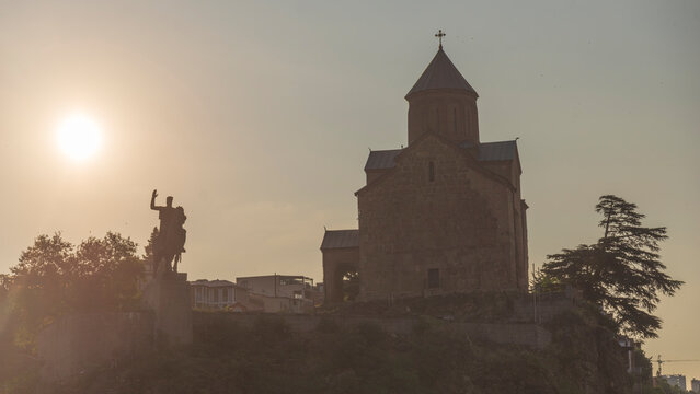 Silhouette of Metekhi church and King Vakhtang Gorgasali monument at sunset with copy space