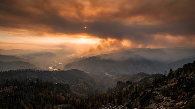 Wildfire sweeps rapidly across rugged mountain slopes at sunset