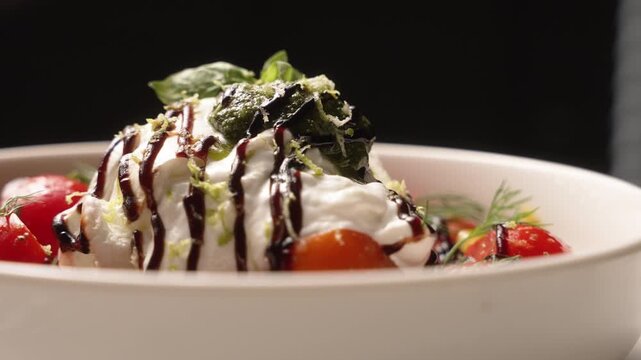 Fresh italian burrata cheese served with cherry tomatoes, basil, pesto, and balsamic vinegar dressing