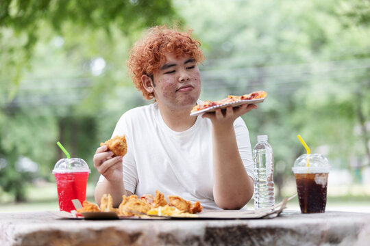 Gen Z Teen Hesitating Between Pizza and Fried Chicken While Choosing Water Over Soft Drink &ndash; Healthy Lifestyle Decision Concept