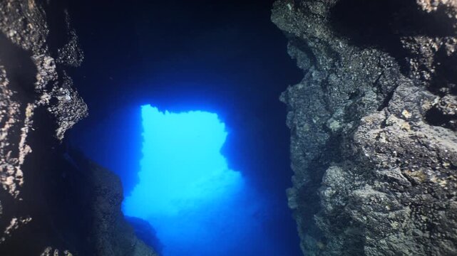 cave diving underwater scuba divers exploring caves and having fun ocean scenery sun beams and rays background