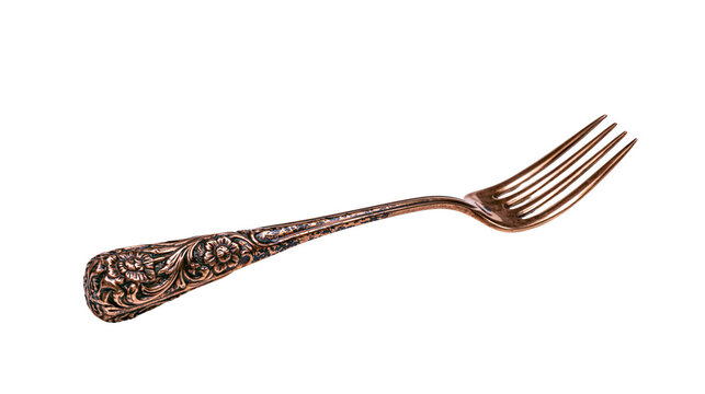 Ornate antique bronze fork with floral engravings, isolated on transparent background