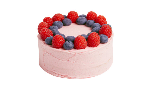 Pink frosted cake decorated with fresh raspberries and blueberries, isolated on transparent background