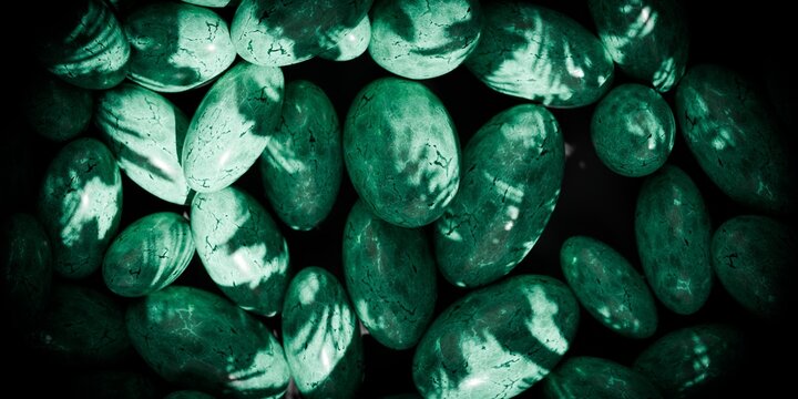 green marbled stones on a black background