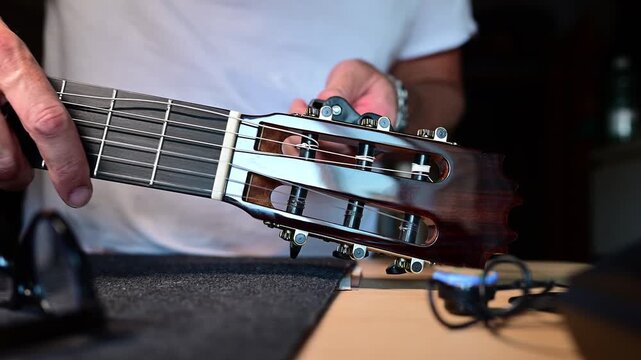 Luthier changing strings on a classical guitar
