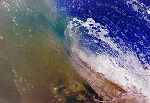 Close-up of a breaking ocean wave showing translucent water and