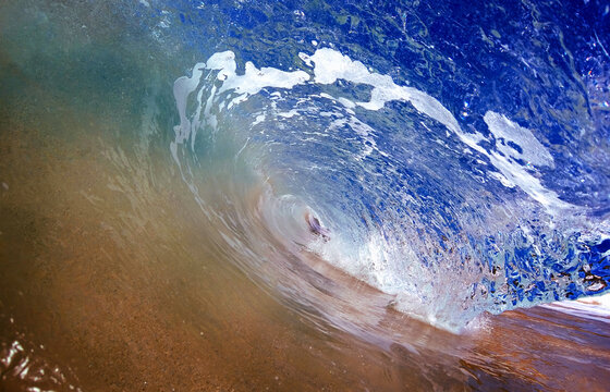 Close-up View of Swirling Ocean Water and White Sea Foam on Wet