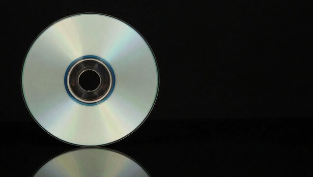 Single Blank Compact Disc CD or DVD on a Reflective Black Surface