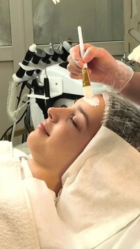 Beautician Applying Facial Mask During Professional Skin Treatment