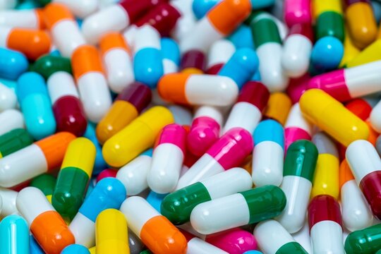 Selective focus on pile of antibiotic capsule pills. Antibiotic drug resistance concept. Colorful capsule pills. Pharmaceutical industry. Healthcare and medicine background. Pharmaceutics concept.