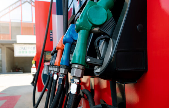 Petrol pump filling fuel nozzle in gas station. Fuel dispenser. Refuel fill up with petrol gasoline. Gas pump handle. Green petrol fuel nozzle. Petroleum oil industry. Oil crisis. Petrol price crisis.
