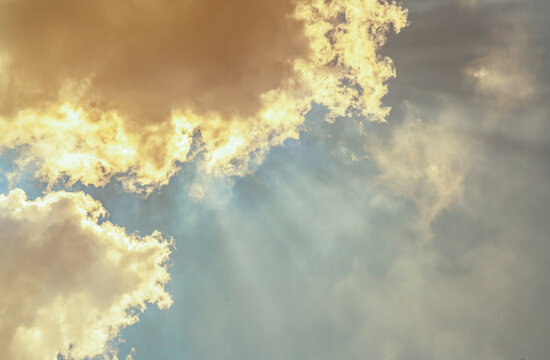 God light. White and golden cloudy sky with sun beam. Sun rays through golden clouds. God light from heaven for hope and faithful concept. Believe in god. Beautiful sunlight sky and fluffy clouds.