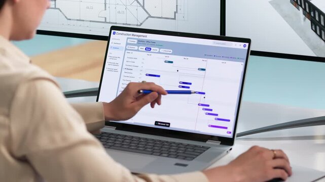 Internal Auditor Reviews Risk Dashboard On Laptop