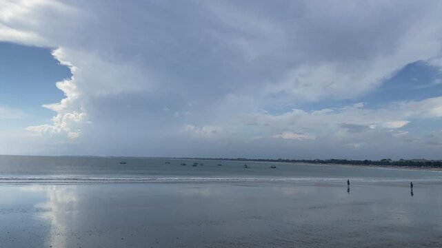 Landscape video, beach sand, clouds over the sea reflection, Bali, Kuta Beach, Indonesia.