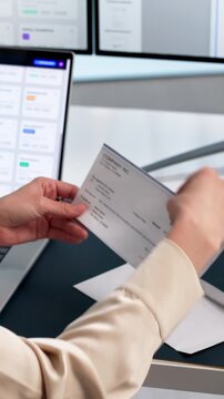 Woman Opening Emvelope With Payroll Check.