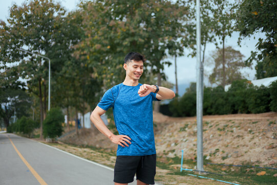 Young man checking smartwatch during outdoor workout