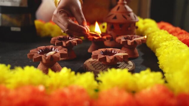 Woman Lighting Diya Oil Lamp During Diwali Festival