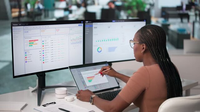 Financial Analyst Reviewing Corporate Cashflow Reports On Laptop