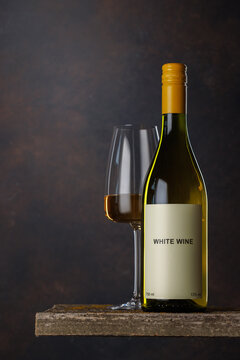 Wine glass and bottle with white wine