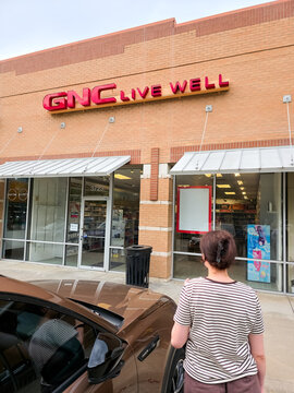 GNC Live Well storefront with a customer outside in Texas