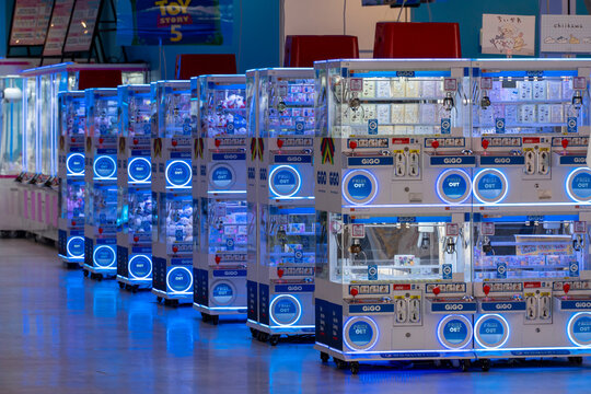 TOSHIMA, TOKYO, JAPAN - JULY 8, 2026: A long perspective row of glowing UFO catcher and crane game prize machines inside a GiGO amusement arcade branch in Toshima-ku, Tokyo.