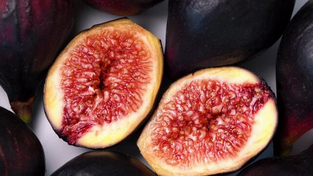 Fresh Ripe Figs on a Rustic Wooden Table with Halved Organic Fruit and Juicy Seeds Close Up Healthy Natural Food Concept